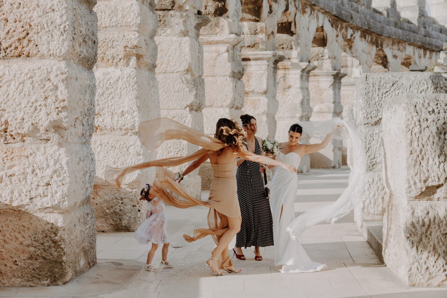 Bride celebrating with family in the historic Arena of Pula during a wedding in Istria, Croatia